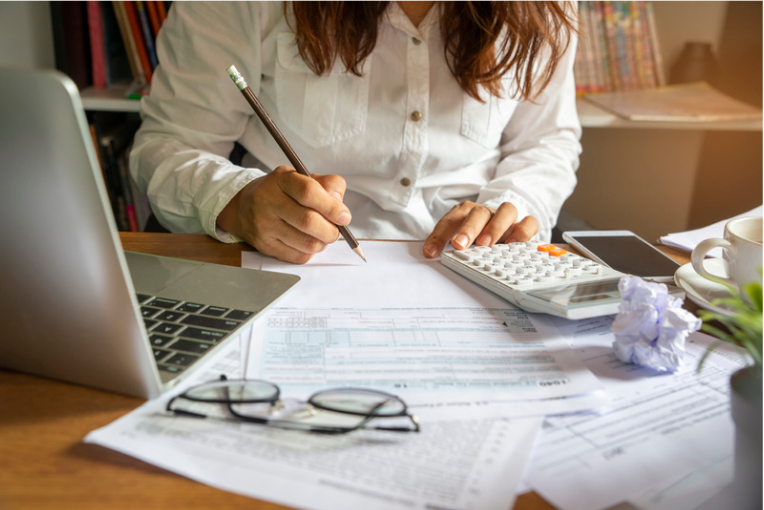 A woman making calculations in pencil